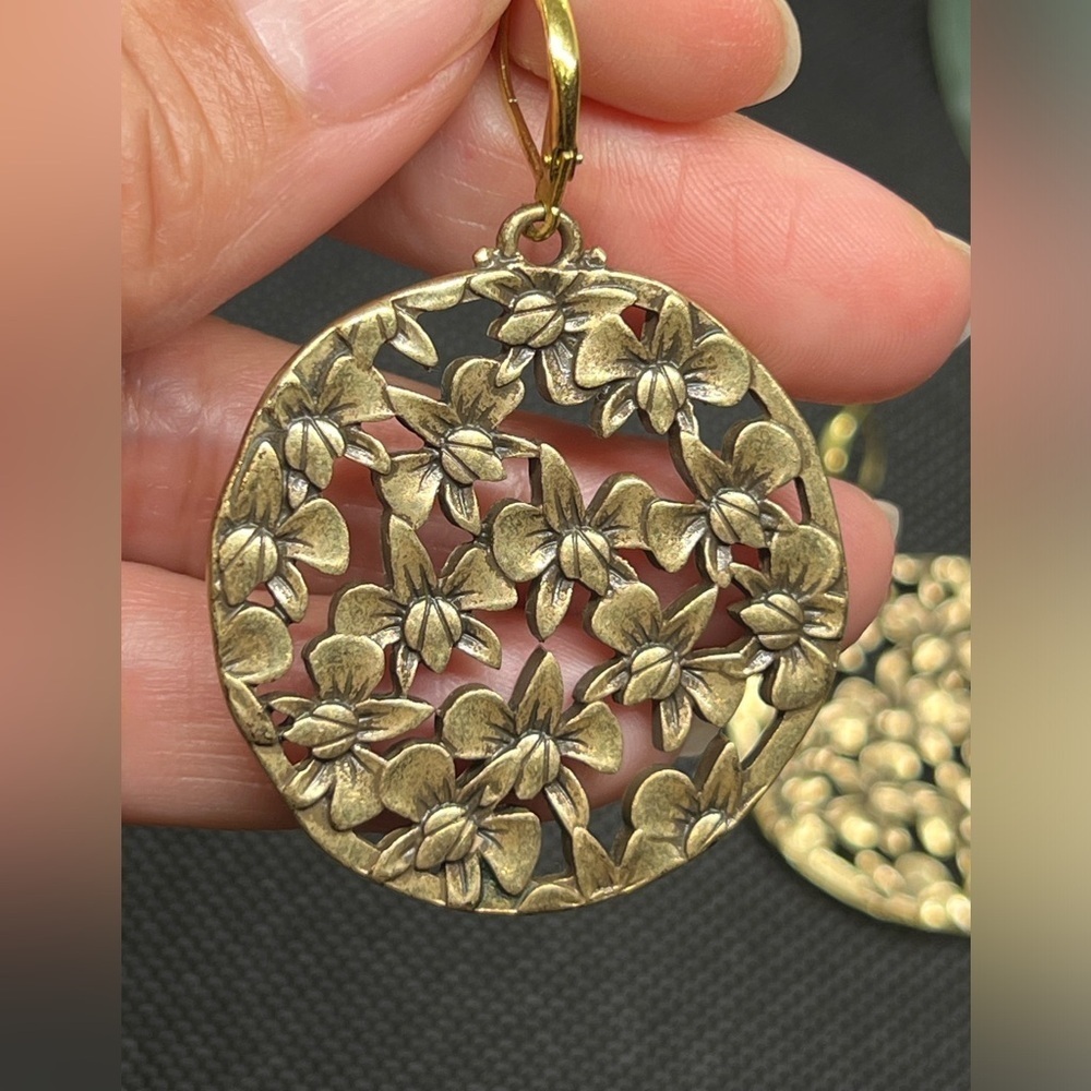 Vintage brassy toned orchid collage round dangle earrings.